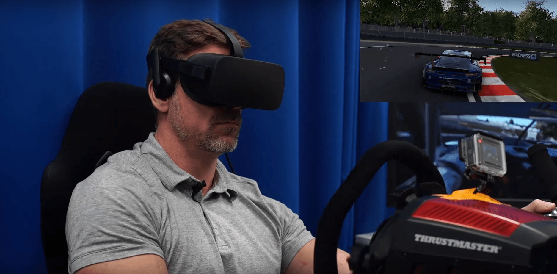 A middle aged man inside a virtual reality driving machine. He is wearing Virtual Reality Glasses (Black).